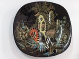 a black plate with a picture of a castle on it