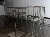 many metal cages in a room with no one on them