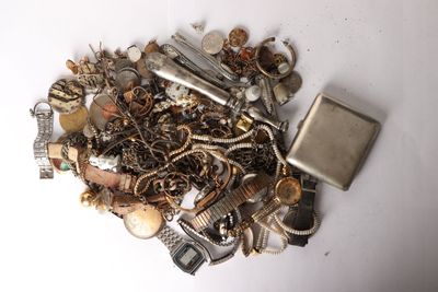 a pile of assorted metal items on a white surface