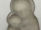 a small statue of a woman holding a baby