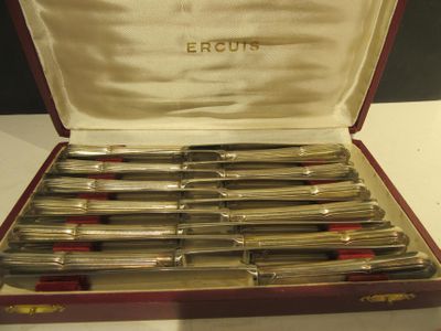 a lot of silverware in a case on a table
