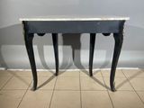 black and white marble topped table with two legs