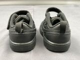 a close up of a pair of shoes on a bed