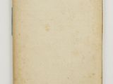 an old book with a blank page on a white surface