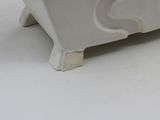 a small white elephant statue sitting on a white surface
