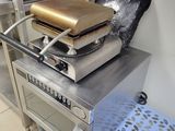 a pizza oven sitting on top of a table in a kitchen