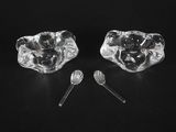 pair of crystal toothbrushes and a spoon on a black surface