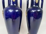 pair of blue vases with gold handles on a white background