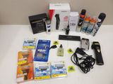 the contents of a shaver, razor, razor blade, and other items are laid out on a table