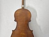 an old violin is sitting on a white surface