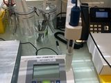 an image of a laboratory table with a microscope and other equipment