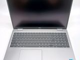 an open laptop computer sitting on top of a white table