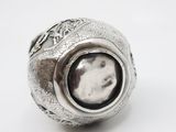an image of a silver ring with a black stone in the center