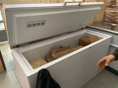 a white chest freezer sitting inside of a kitchen