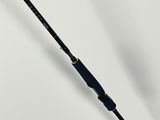 a close up of a fishing rod on a white surface
