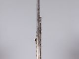 a close up of a silver flute on a clear surface