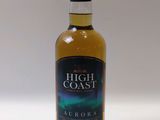 a bottle of high coast aurora whisky sitting on a white surface