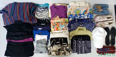 a white box filled with lots of clothes and shoes