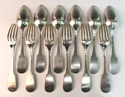 a lot of silver spoons and forks on the table