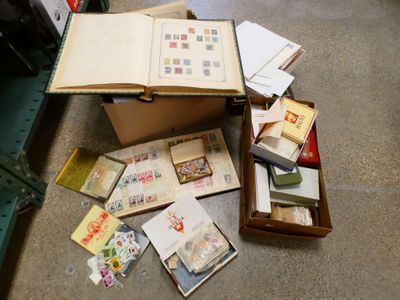 a box full of books and postcards on the floor