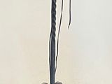 wrought iron candelab with three candles on top of it