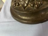a gold plate with a flower design on it on a white cloth