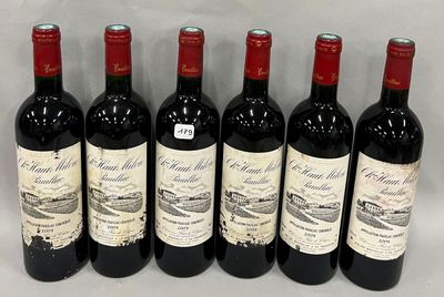 six bouteilles de vin rouge alignées sur une surface blanche