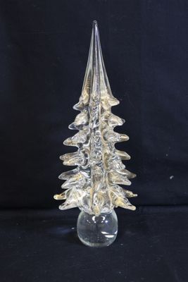 clear glass christmas tree sitting on top of a clear glass base