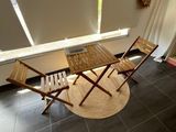 a table and chairs in a room with a large window