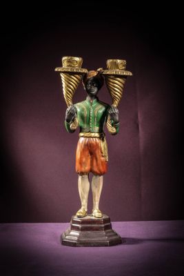 a statue of a man holding two baskets on his head