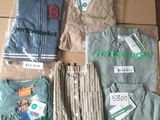 a lot of clothes that are sitting on a cardboard box