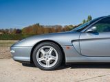 a silver sports car parked on the side of the road