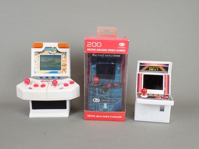 two small toy video game consoles sitting next to each other
