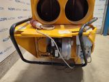 a large yellow machine with two large speakers on it