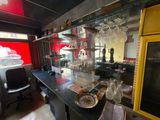 a kitchen with a counter and a bar with wine glasses on it