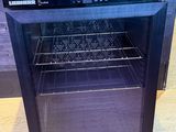a small black oven with a glass door on the floor