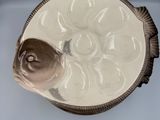 a white vase with a brown decoration on it