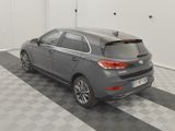 a picture of a grey car parked in a garage