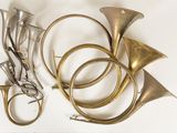 a lot of brass instruments that are laying on a table