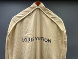une vieille veste Louis Vuitton suspendue à un cintre