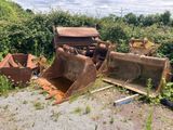 a bulldozer sitting in the middle of a field