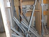a pile of pipes and pipes in a room that is under construction