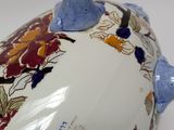 a white and blue vase with a bird on it