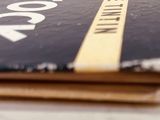 a book sitting on top of a table next to a cup of coffee