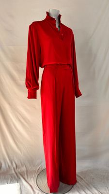 red jumpsuit on mannequin base against white backdrop