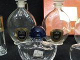 several bottles of perfume sitting on top of a table next to a box