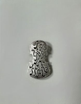 a close up of a metal object on a white surface