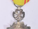 silver medal with a red and yellow ribbon on a white background