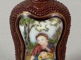 a small bottle with a picture of a child on it