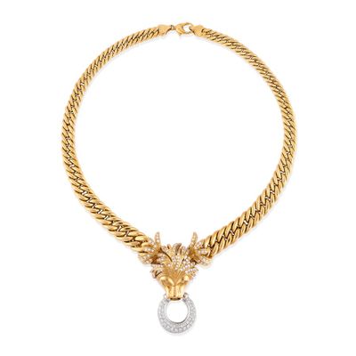 a gold and diamond necklace with a lion head